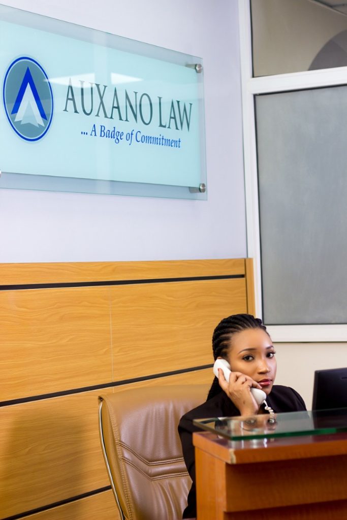 Lady sitting at reception answering a phone call